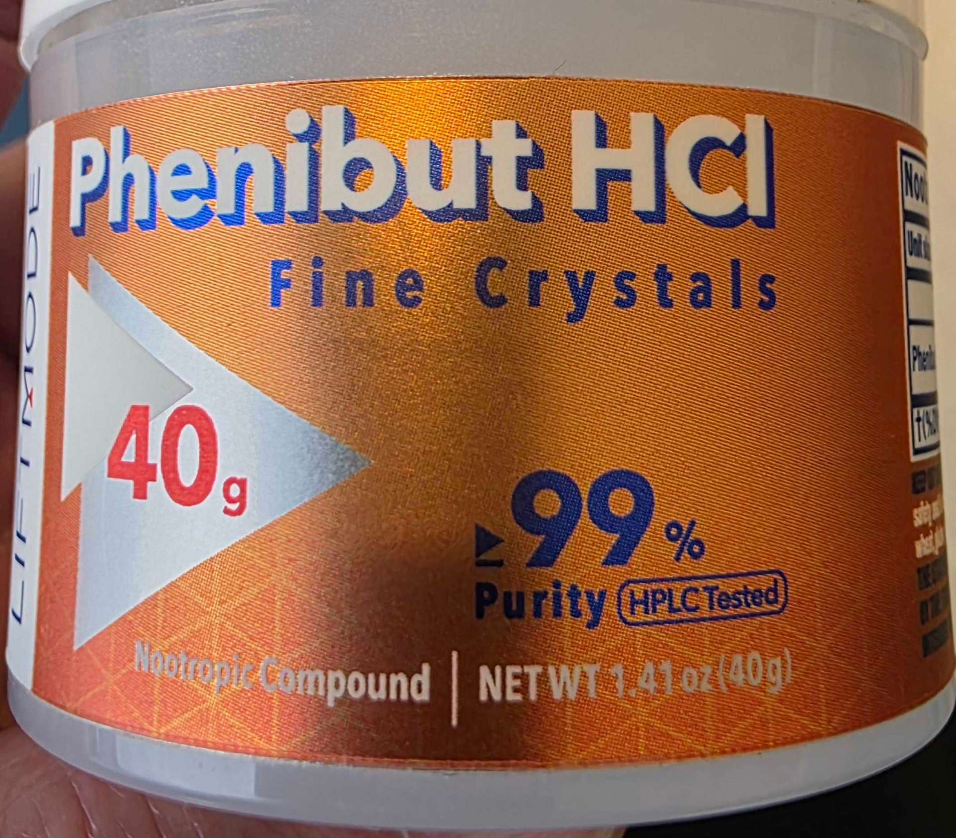 A container of phenibut hydrochloride powder sold as a nootropic compound, with a purity claim and no warning label